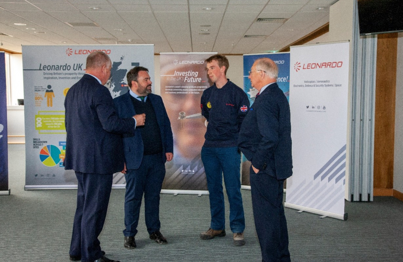 Pictured: Chris Loder MP talking with an apprentice from West Dorset and the Managing Director for Leonardo Helicopters