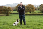 Chris Loder in a field with his rescue dog, Poppy