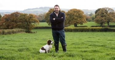 Chris Loder in a field with his rescue dog, Poppy