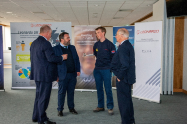 Pictured: Chris Loder MP talking with an apprentice from West Dorset and the Managing Director for Leonardo Helicopters